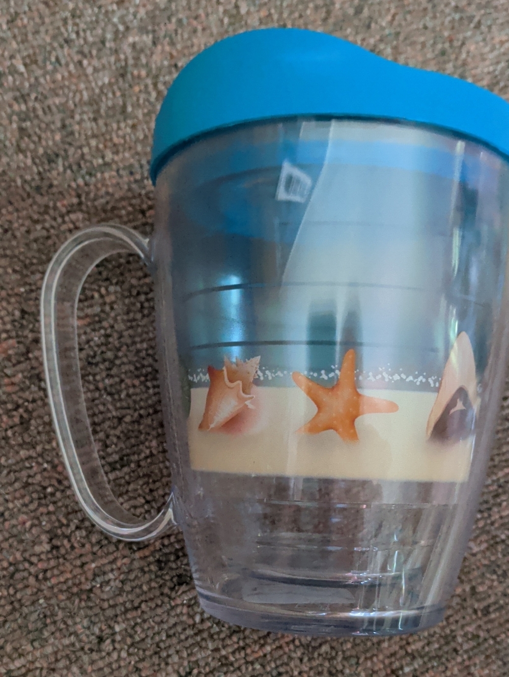 tervis blue lid clear travel mug with seaside shell design